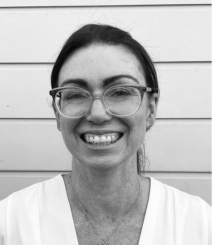 A black and white photo of a woman smiling