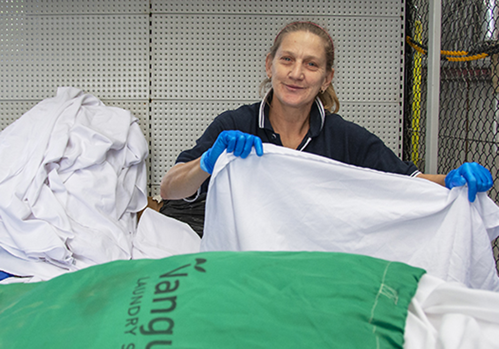 Photo of a woman working with Vanguard Laundry Services