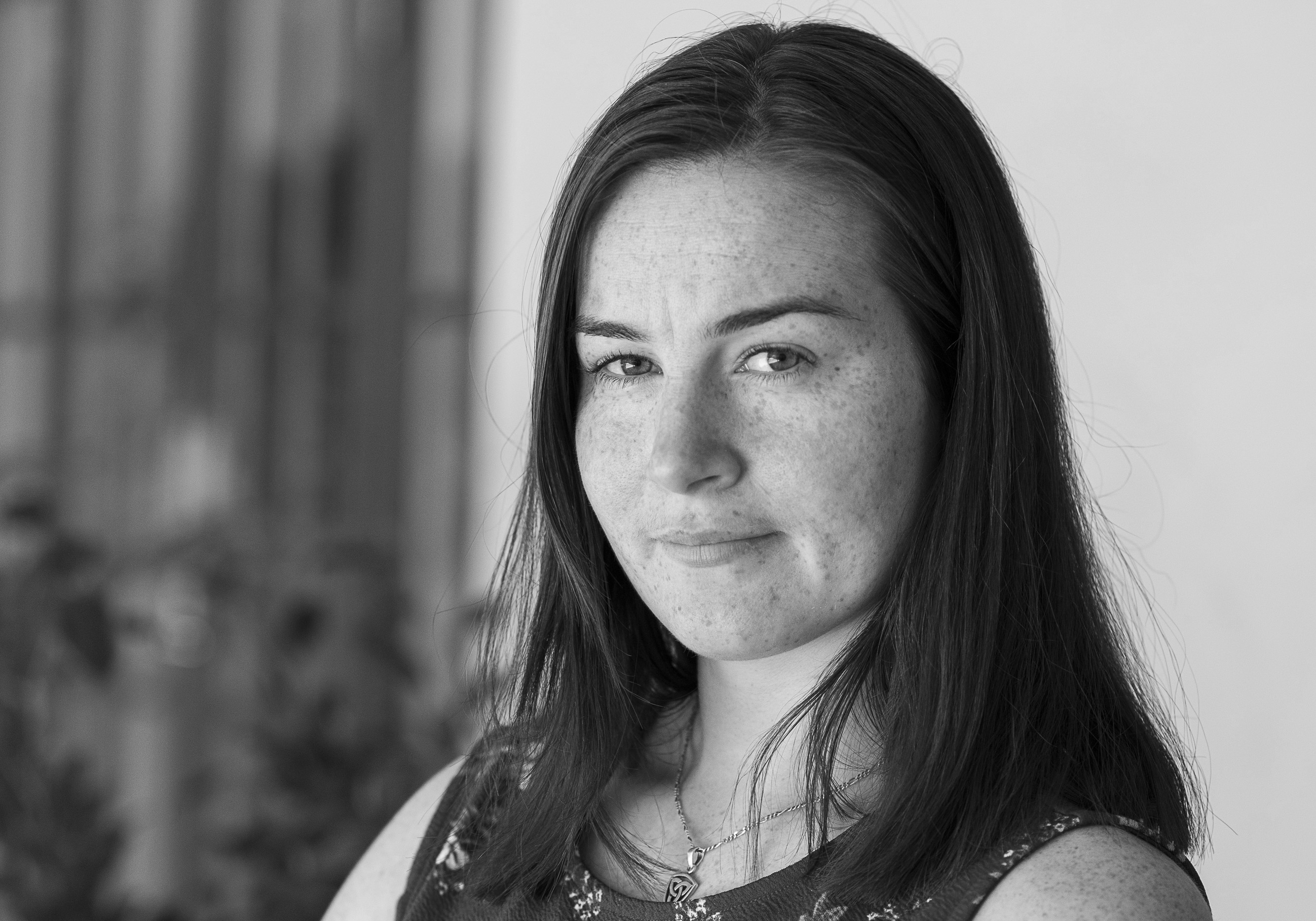 Photo of Emma Barnes. She has long dark hair, and is looking at the camera.