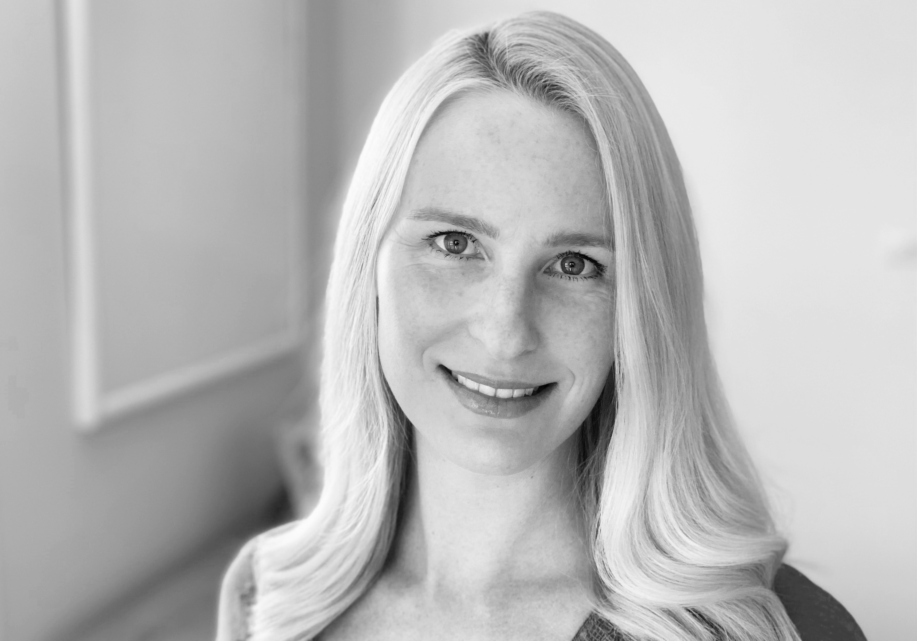 Photo of Georgi MacDiarmid. She has long hair, and is smiling at the camera.